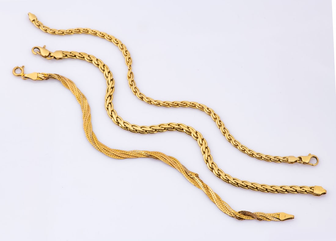 A Group of Three French 18K Yellow Gold Link Bracelets: A Group of Three French 18K Yellow Gold Link Bracelets Comprising link bracelets, each bearing an eagle head hallmark and acid tested. Two bracelets show age-related wear and some imperfections