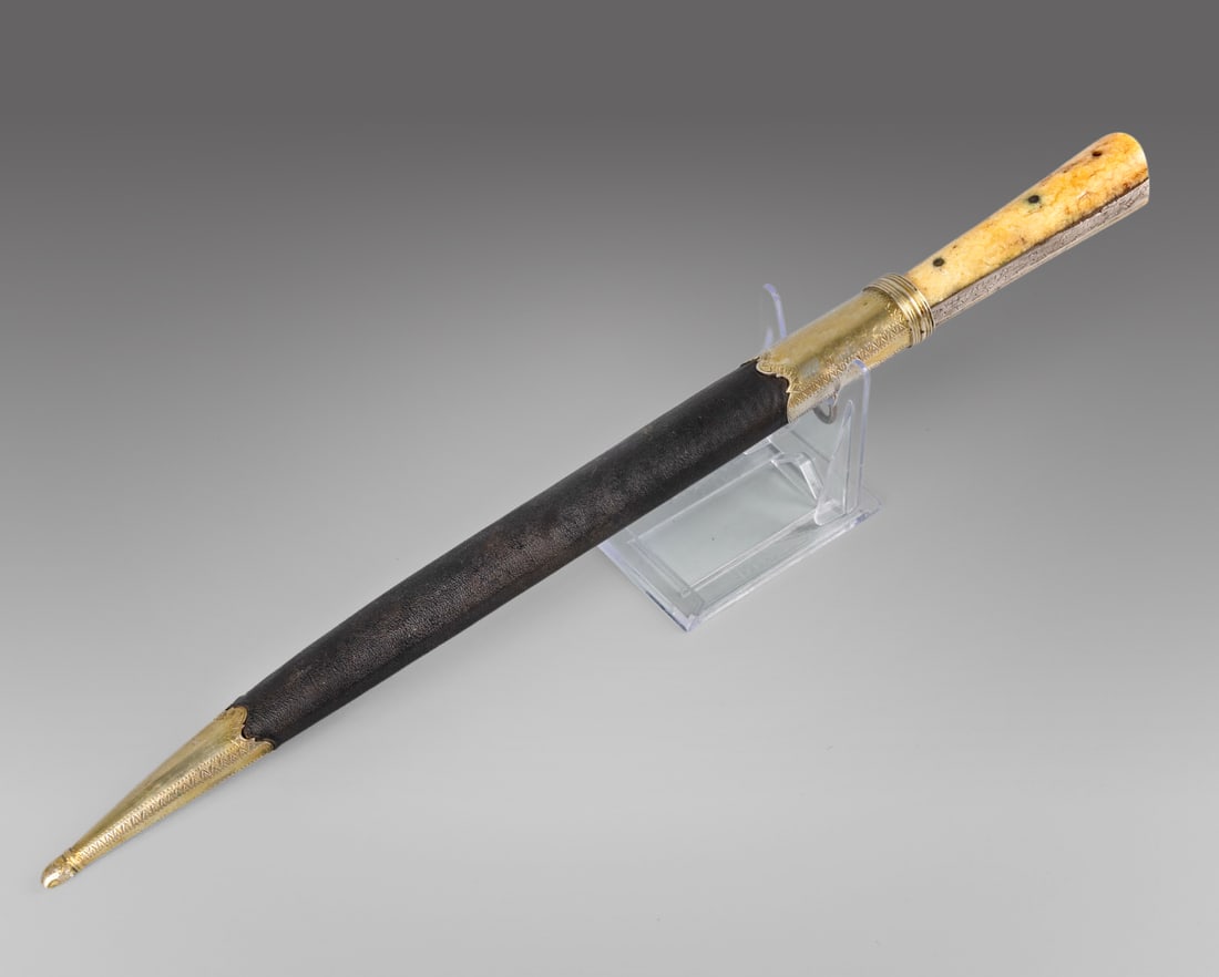 An Ottoman Bone and Silver â€?Kardâ€? Dagger, 19th Century: An Ottoman Bone and Silver â€?Kardâ€? Dagger, 19th Century The polished bone handle is fitted with a finely engraved silver element, set at the base with a cabochon-cut turquoise. The bla