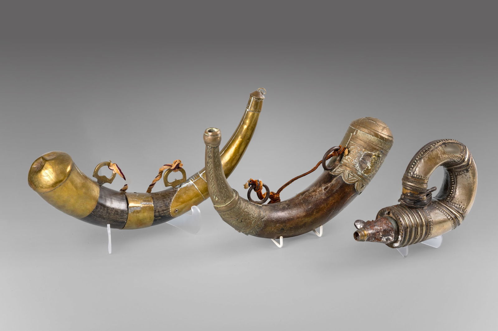 A Group of Three Ottoman Powder Horns of Brass, Silver, and Natural Materials, North Africa, (1 of 4)
