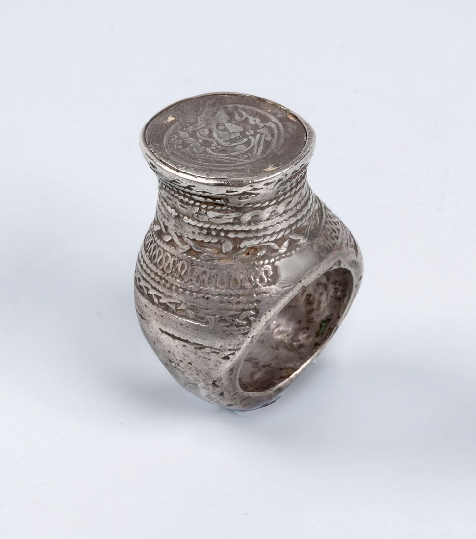 A Large Silver and Silver Filigree Ring, Afghanistan, 19th Century: A Large Silver and Silver Filigree Ring, Afghanistan, 19th Century Decorated with numerous rows of twisted silver wires in various patterns rising up the shoulders of the ring. The crown is set with