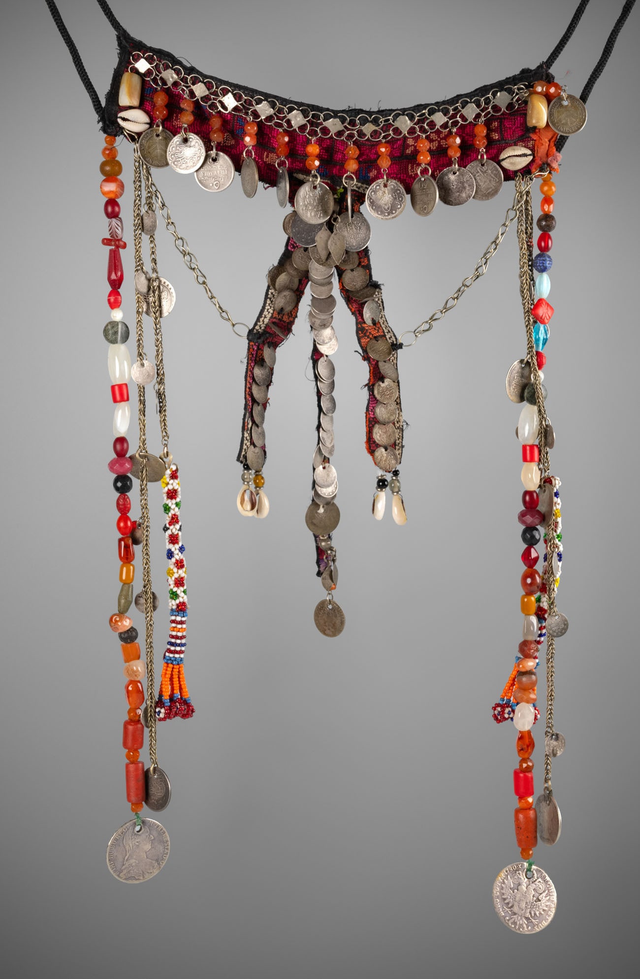 An Impressive Palestinian Bridal Head Ornament, First Half of the 20th Century: An Impressive Palestinian Bridal Head Ornament, First Half of the 20th Century A striking ornament composed of embroidered fabric bands in multicolored threads, interwoven with silver chains, Austria