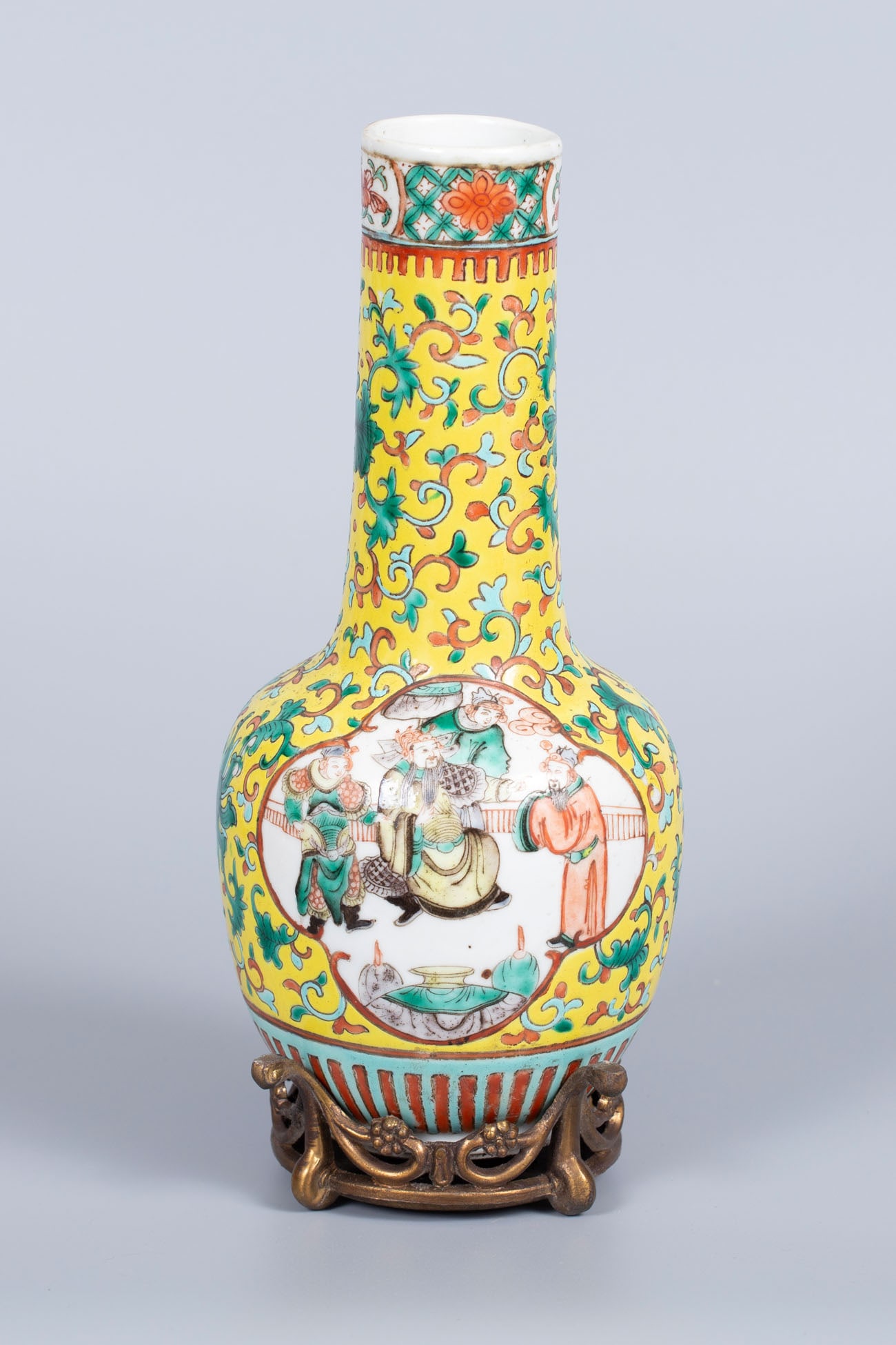 A Famille Jaune Polychrome Porcelain Vase, China, Late Qing Dynasty: A Famille Jaune Polychrome Porcelain Vase, China, Late Qing Dynasty Decorated with yellow relief work and centered with two traditional scenes depicting Chinese philosophers. With matching brass stand