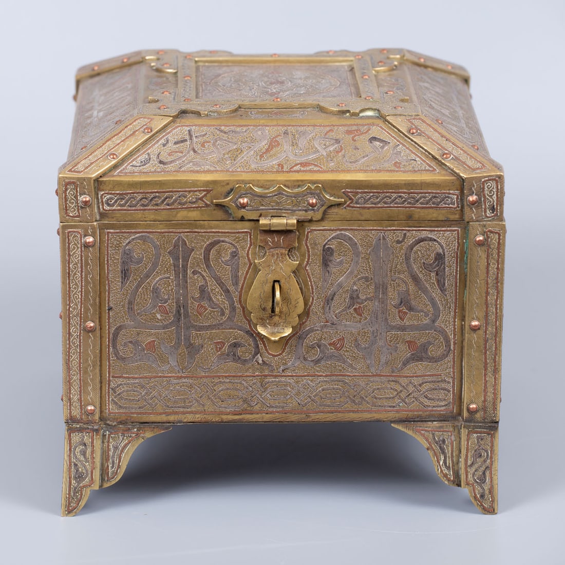 A Luxurious Damascene Brass Silver and Copper Inlay Chest, Syria, 19th Century: A Luxurious Damascene Brass Silver and Copper Inlay Chest, Syria, 19th Century Square form raised on four stylized feet. The sides and lid richly decorated with silver and copper inlay forming Arabic 