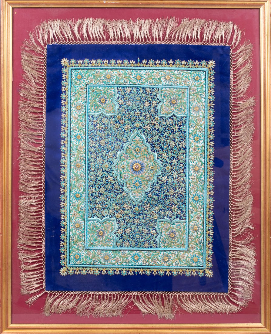 An Indo-Persian Zardozi Embroidery: An Indo-Persian Zardozi Embroidery Dense metallic thread embroidery on blue textile featuring intricate floral and organic motifs with a central medallion in traditional Indo-Persian design.The work i