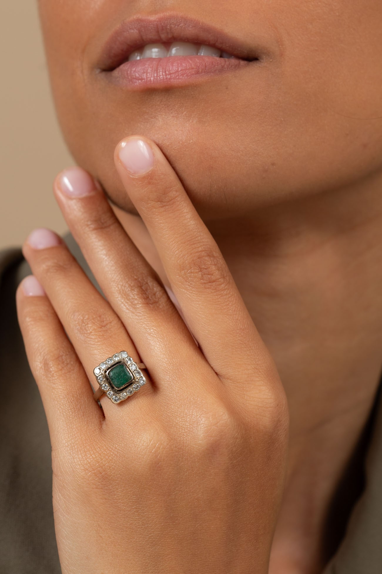 A 14K Yellow Gold Emerald and Diamond Halo Ring: A 14K Yellow Gold Emerald and Diamond Halo Ring Square-shaped head centering a emerald (approx. 0.50 Ct) framed by a halo of small diamonds (approx. 0.40 Ct in total. color: H-I, clarity: SI). Marked.