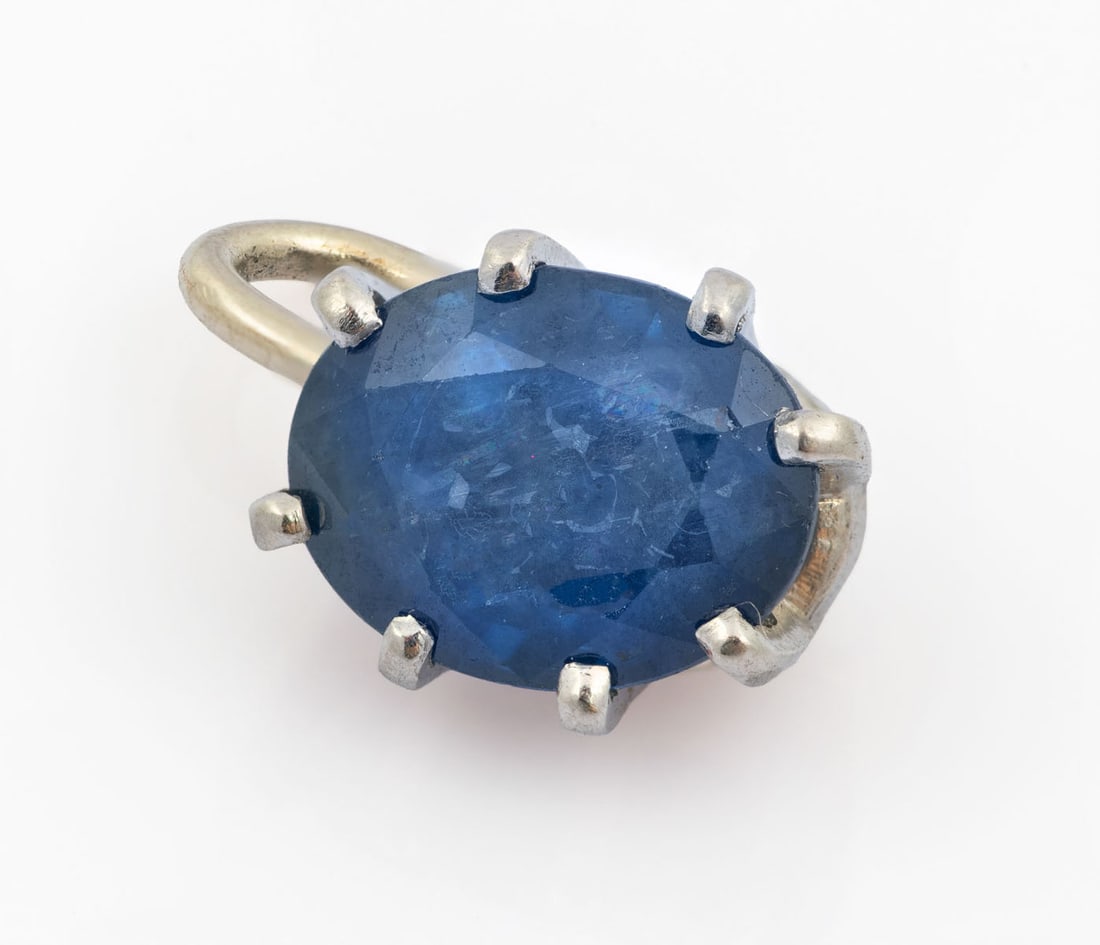 A Platinum and 14K White Gold Sapphire Solitaire Pendant: A Platinum and 14K White Gold Sapphire Solitaire Pendant Set with an oval-cut sapphire (approx. 2 Ct; sapphire dimensions: 9 x 6.5 mm). The bail in 14K white gold. Acid tested.Total weight: 2 gr; pend