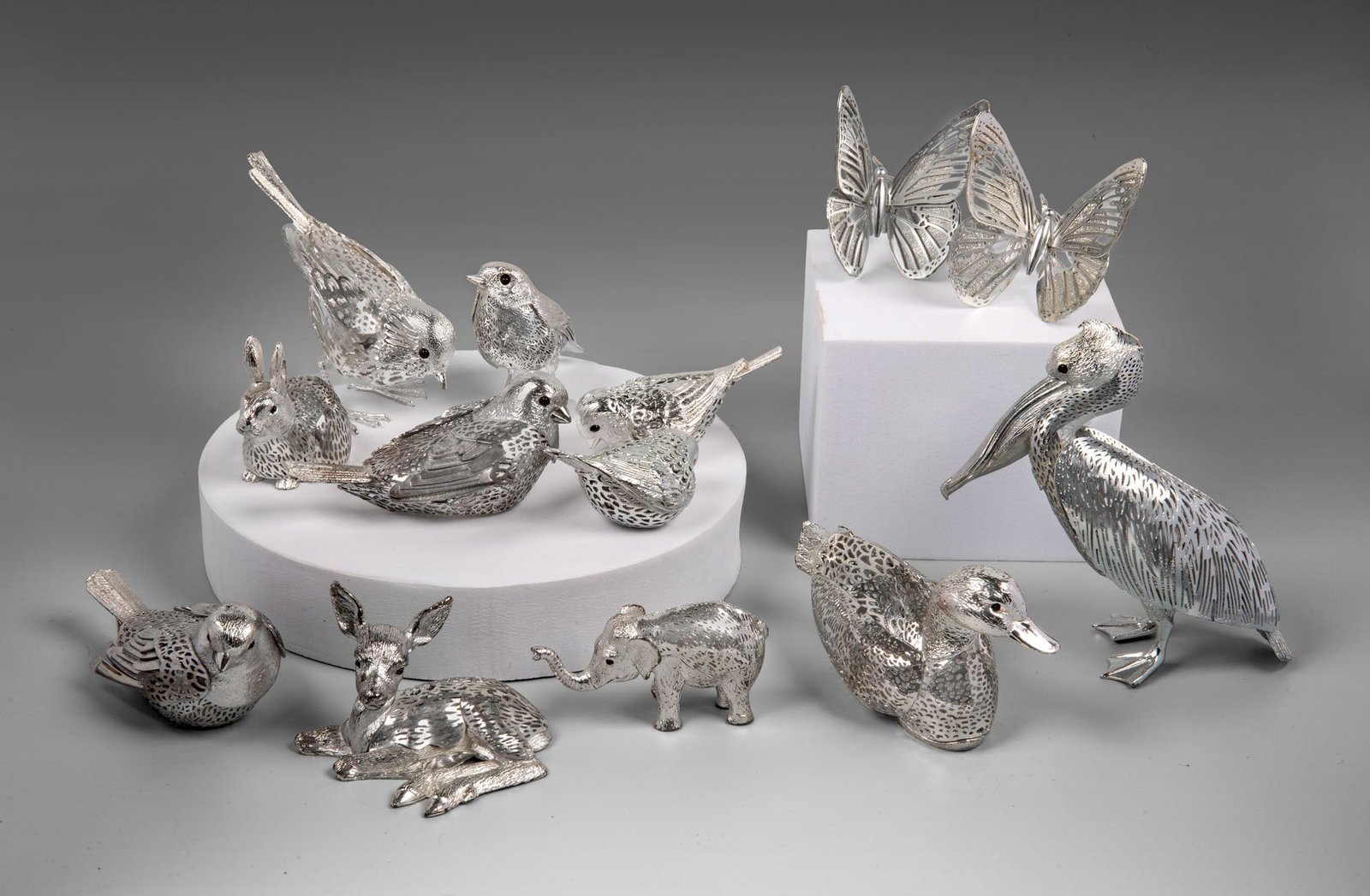 A Set of Small Christofle Silver-Plated Figurines, France, 20th Century: A Set of Small Christofle Silver-Plated Figurines, France, 20th Century Designed as various animals including birds, mammals, and butterflies, with delicate lacework-style detailing. Marked. Height be