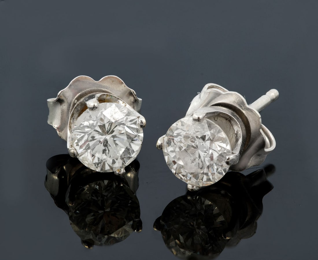 A Pair of 14K White Gold Diamond Solitaire Stud Earrings: A Pair of 14K White Gold Diamond Solitaire Stud Earrings