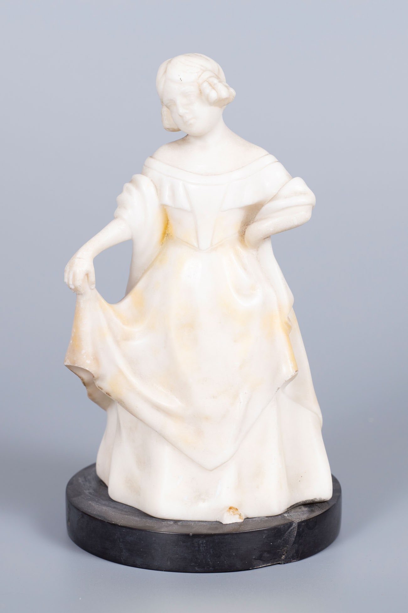 A Goldscheider White Marble Figurine, Vienna, Early 20th Century: A Goldscheider White Marble Figurine, Vienna, Early 20th Century Set on a black marble base. Marked with an impressed stamp, artist's signature and numbering. Small break to one leg and a restoration