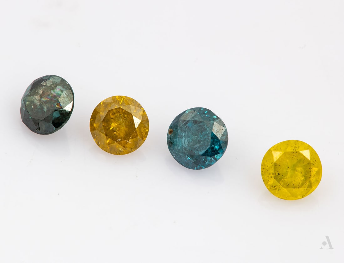A Group of Four Natural Fancy-Colored Diamonds, Totaling 1.05 Ct: A Group of Four Natural Fancy-Colored Diamonds, Totaling 1.05 Ct Comprising four colored diamonds: two yellow and two blue, all brilliant-cut (Diameter range: 3.75-4 mm; Total weight: 1.05 Ct). Notes:
