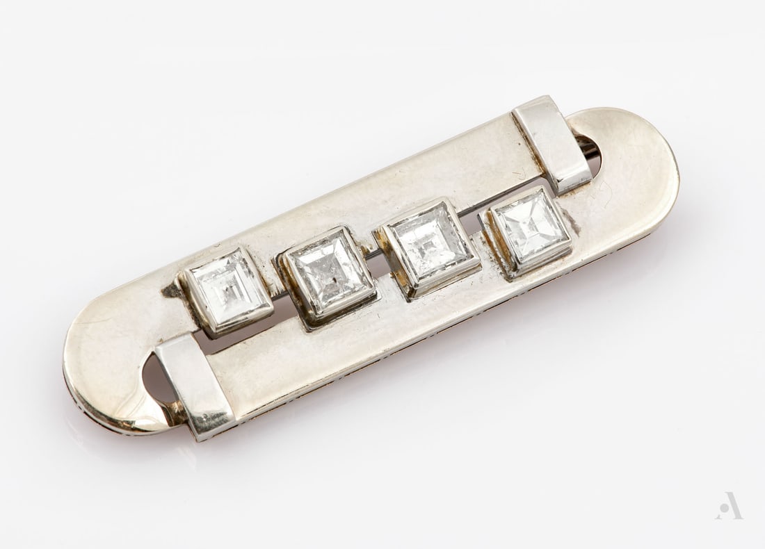 An Art Deco 14K White Gold and Diamond Brooch: An Art Deco 14K White Gold and Diamond Brooch Set with four square-cut diamonds (two central stones each approx. 0.4 Ct and two side stones each approx. 0.3 Ct, totaling approx. 1.4 Ct). The pin likel