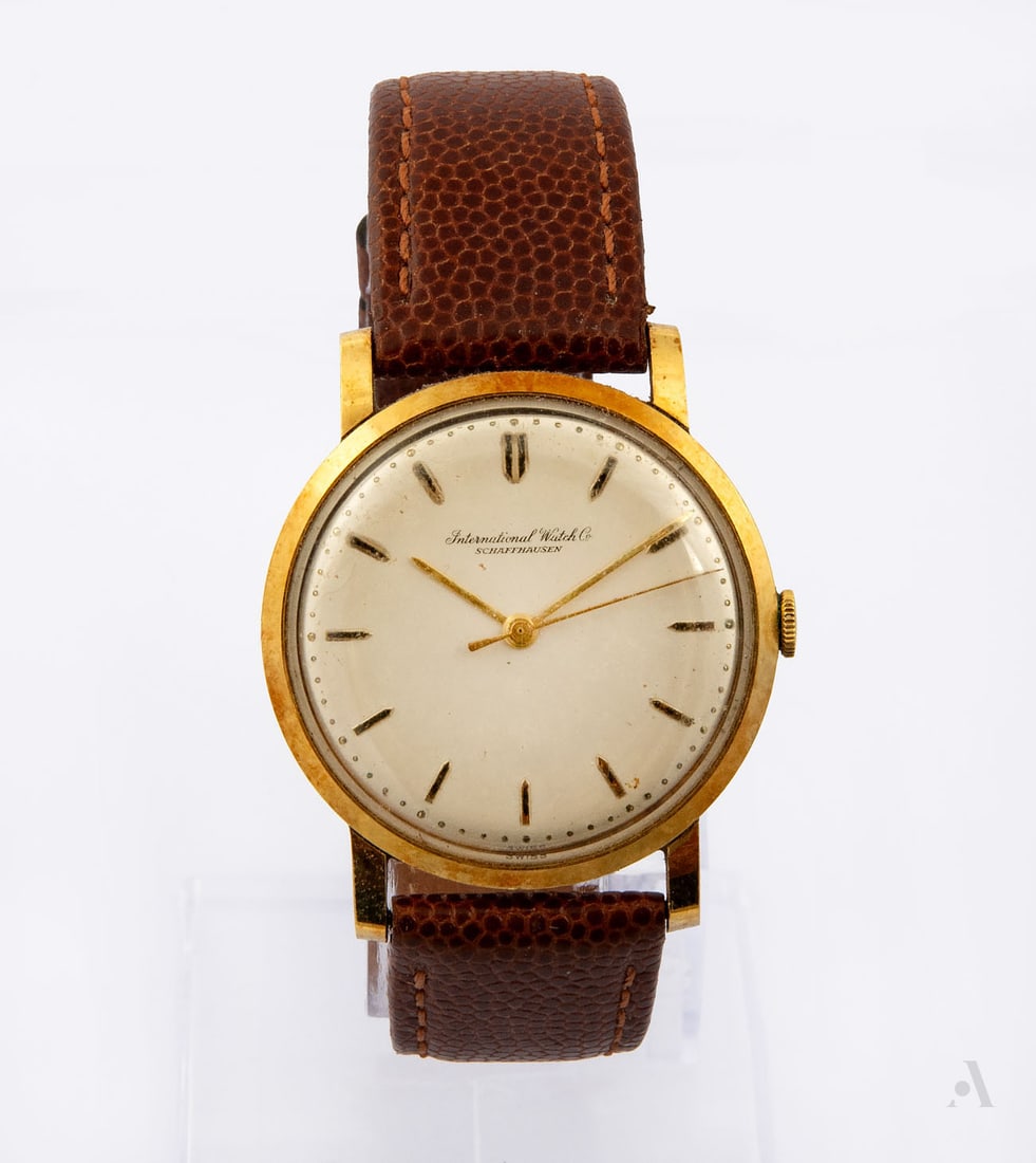 A Vintage IWC Schaffhausen 18K Gold Men's Wristwatch, Switzerland, 1960s: A Vintage IWC Schaffhausen 18K Gold Men's Wristwatch, Switzerland, 1960s Movement: Mechanical, calibre 88/89 Case: 18K gold Dial: White with gold markers Band: Brown leather strap Diameter: 33 mm; wei