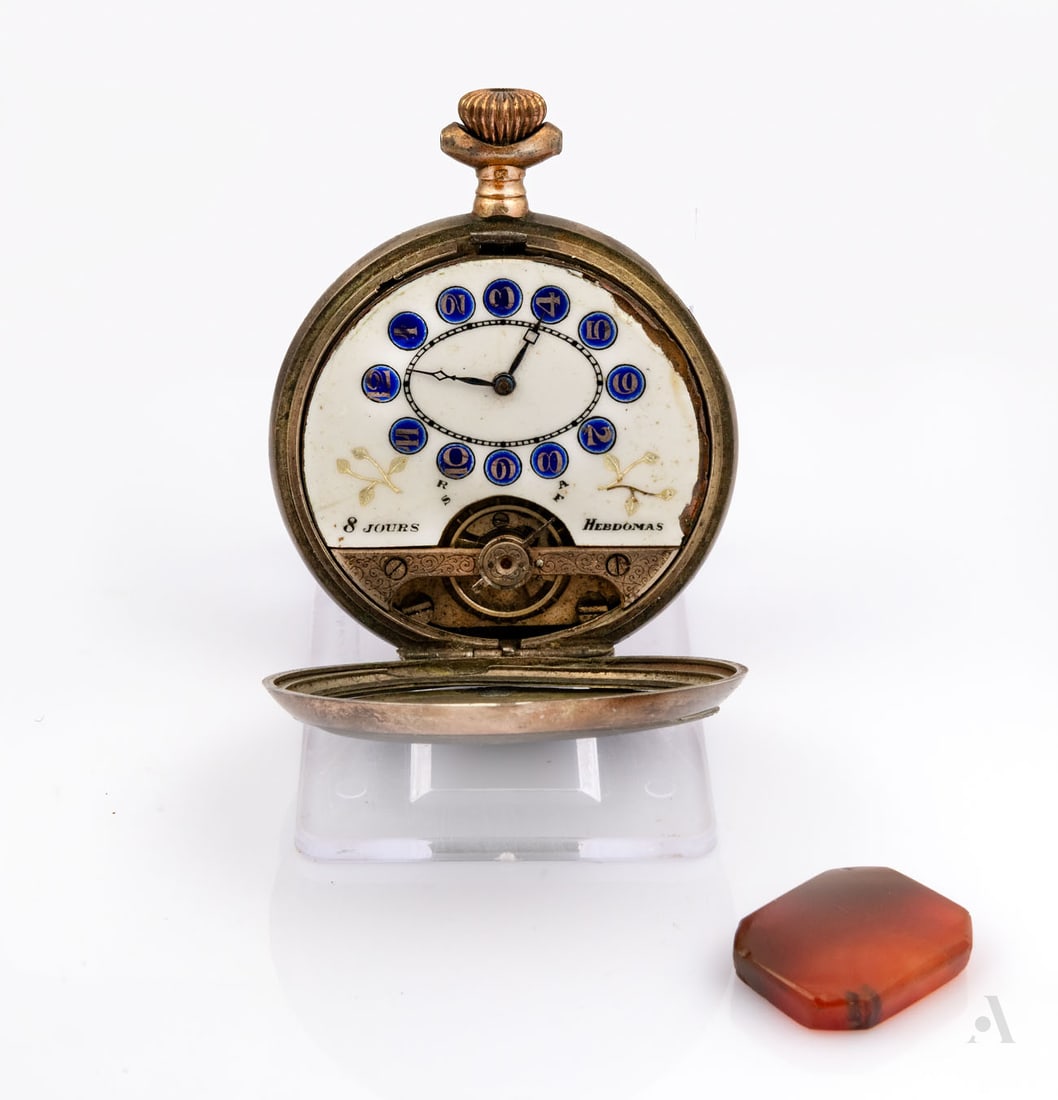 A Hebdomas Silver Pocket Watch, Switzerland, ca 1900: A Hebdomas Silver Pocket Watch, Switzerland, ca 1900 Diameter: 47 mm; total weight: 88.4 g Notes: Showing wear and losses; apparently not in working condition. Accompanied by a carnelian plaque.