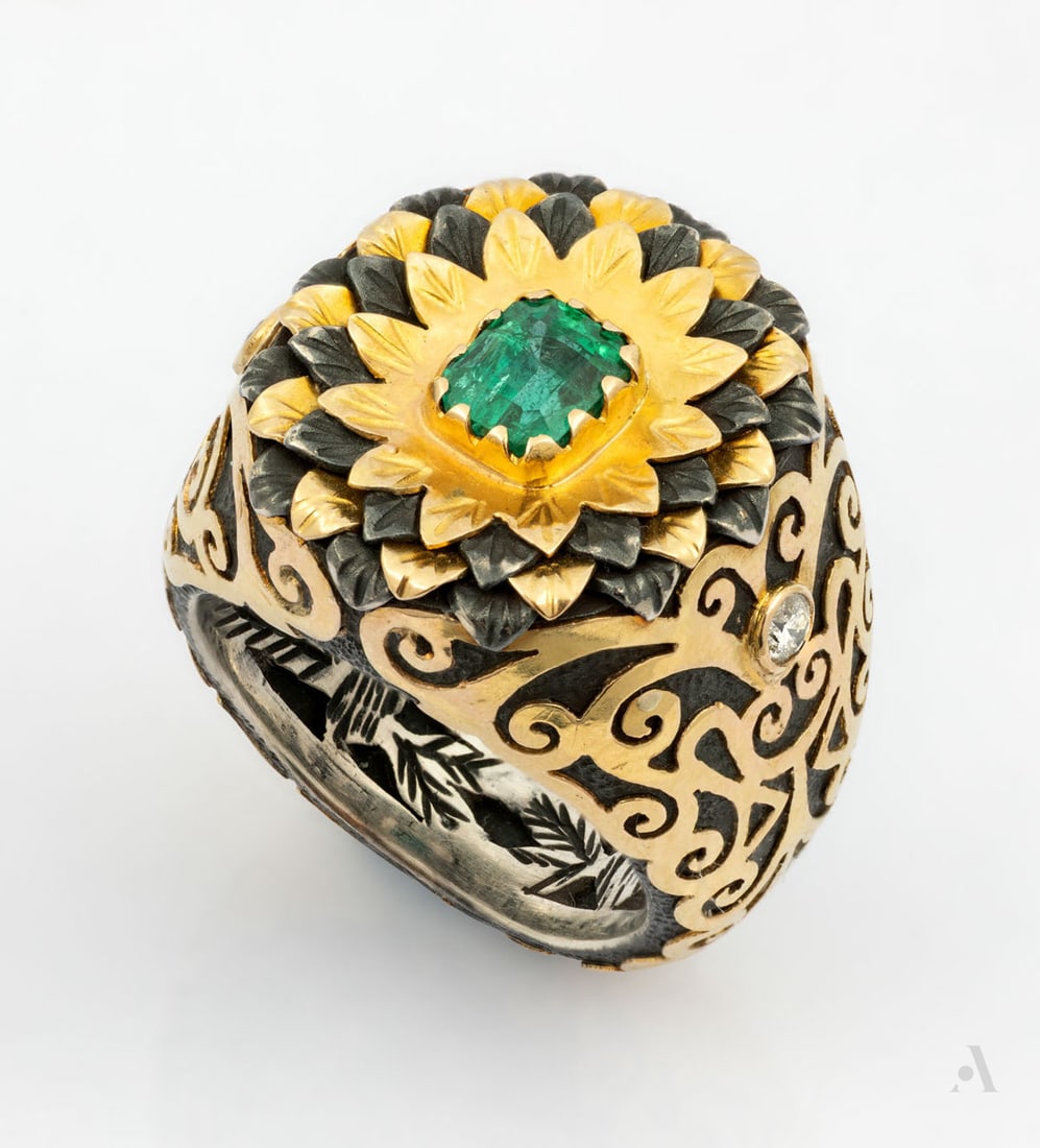 A Silver and 18K Yellow Gold Diamond and Emerald Bombe Ring: A Silver and 18K Yellow Gold Diamond and Emerald Bombe Ring Designed as a flower with petals of sterling silver and 18K yellow gold, centered by an emerald (approx. 0.25 Ct). The outer and inner shank