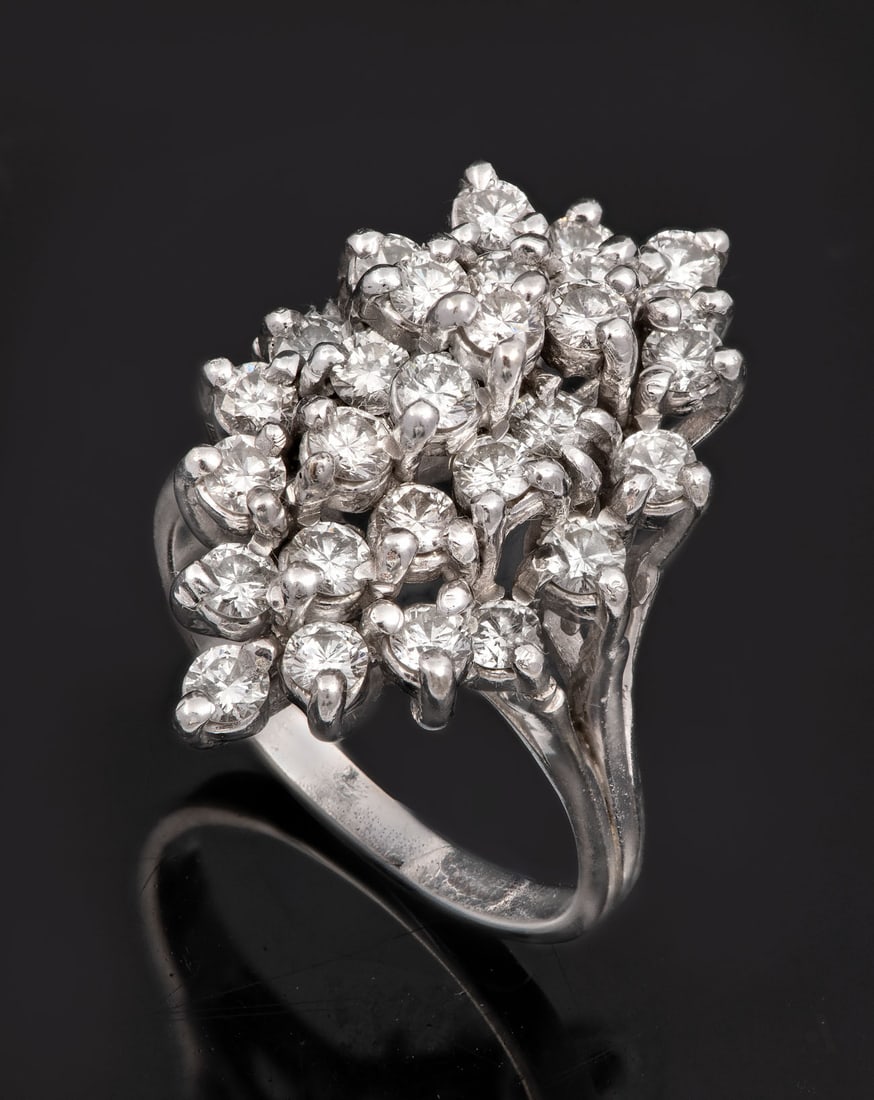 A 14K White Gold and Diamond Cluster Ring: A 14K White Gold and Diamond Cluster Ring The head in a marquise form open worked and set with clusters of brilliant-cut diamonds (approx. 1.5 Ct in total). Gold acid tested. Total weight: 8.15 