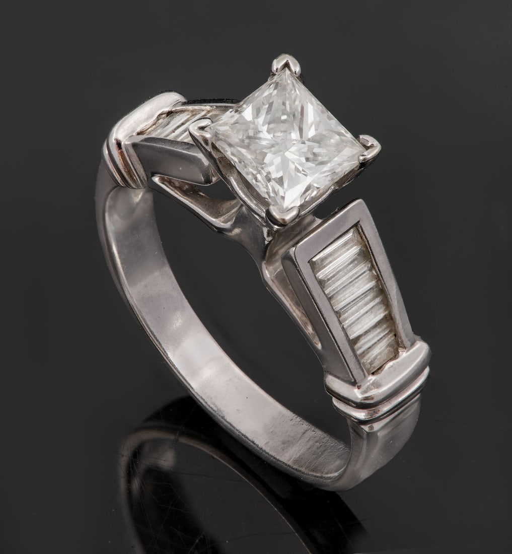 A 14K White Gold and Diamond (Central approx. 0.8 Ct) Solitaire Ring: A 14K White Gold and Diamond (Central approx. 0.8 Ct) Solitaire Ring The head with a raised gallery set with an elongated princess-cut diamond (approx. 0.8 Ct, color: G-I, clarity: SI-VS), flanked ben