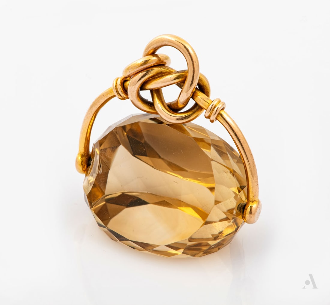 A Victorian 15K Yellow Gold and Citrine Fob Pendant, England, Birmingham, 1866: A Victorian 15K Yellow Gold and Citrine Fob Pendant, England, Birmingham, 1866 A polished citrine suspended from a gold tubular element designed as a knotted string. Marked and gold acid tested. small