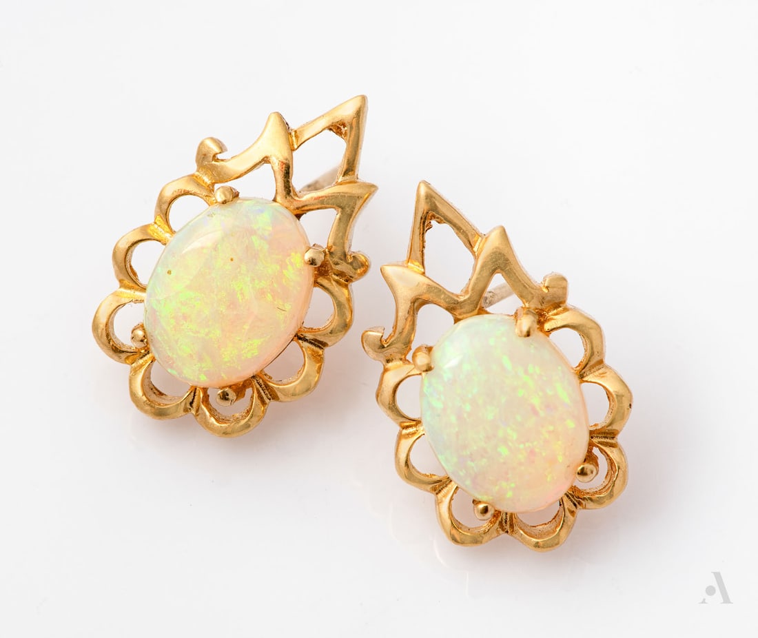 A Pair of 14K Yellow Gold and Opal Earrings: A Pair of 14K Yellow Gold and Opal Earrings Each centered by a cabochon opal (natural origin unknown) in an openwork gold frame. Gold acid tested. Length: 1.7 cm; Total weight: 2.85 gr Condition: