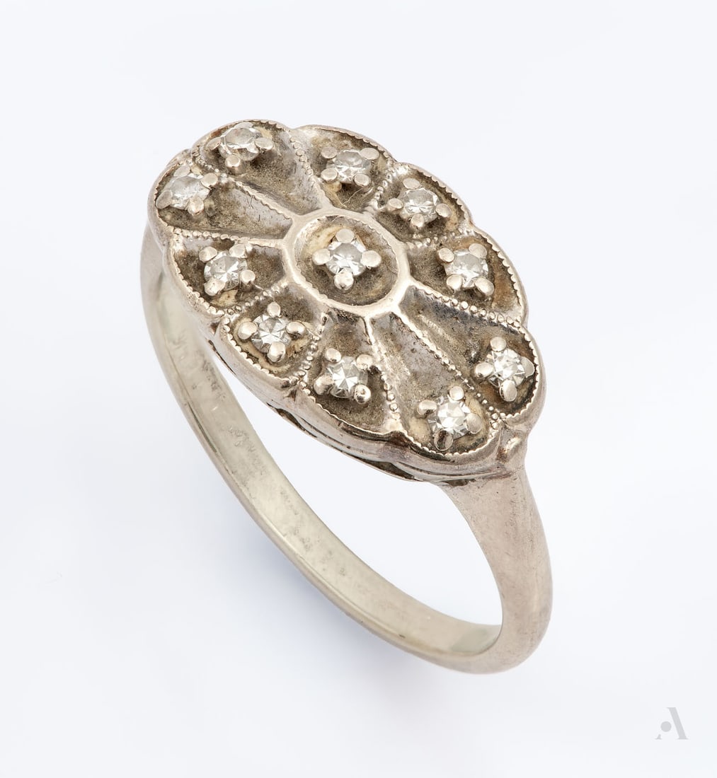 A Vintage 14K White Gold and Diamond Ring: A Vintage 14K White Gold and Diamond Ring Centered by small round-cut diamonds. Gold acid tested. Total weight: 3.79 gr; ring size: 6.25 Condition: For a full condition report please contact: office@a
