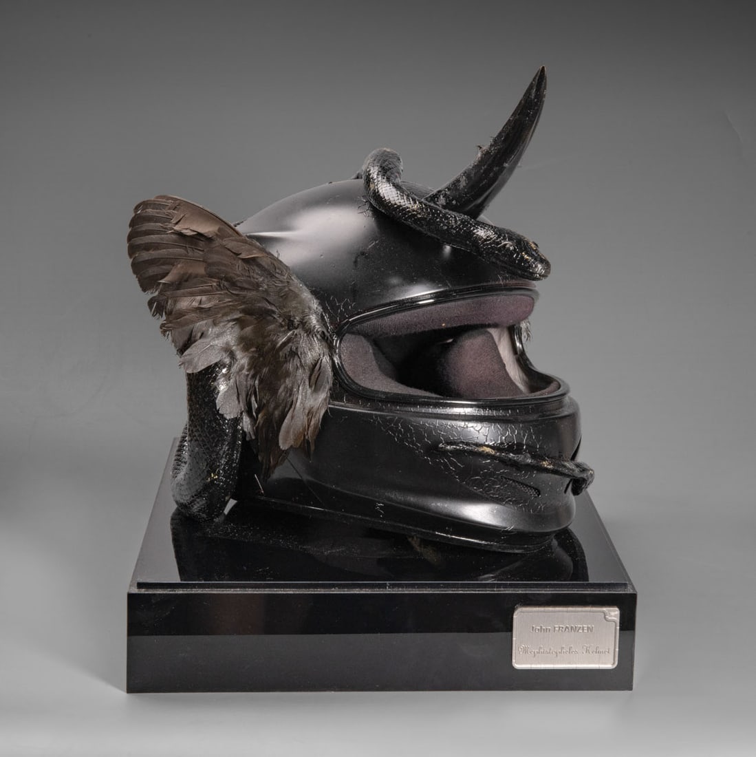 John Franzen (1981), Mephistopheles Helmet: John Franzen (1981), Mephistopheles Helmet Black horn wings and serpent Signed (on the reverse). 48 x 35 x 40 cm Provenance: Private collection, Tel Aviv. Condition: For a condition re