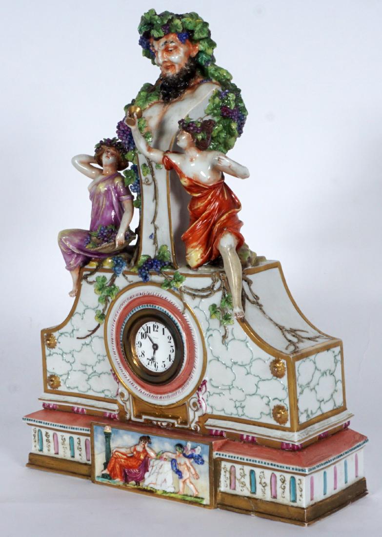 Capodimonte Style Porcelain Clock: CAPODIMONTE STYLE PORCELAIN CLOCK: Figural bust of Bacchus final surmounted by 2 maidens with flowing robes, grape vines all over. Base with relief figure of seated maiden and cherub, replaced quartz