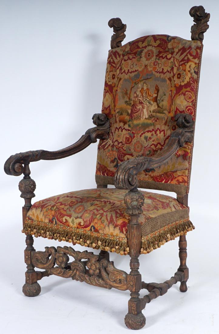 Victorian Gothic Revival Arm Chair: VICTORIAN GOTHIC REVIVAL ARM CHAIR: Carved oak frame with acanthus leaf finials, shaped arms ending in leaf hand holds, foliate scroll openwork skirt, front ball feet. Scenic needle point upholstery w