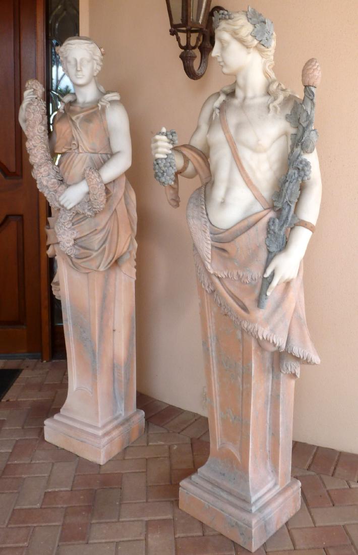 Large Pair Neoclassical Marble Man and Woman: Upper half figures of a man and woman, no visible signatures, to include 1) Man with white head and body, holding a staff and bunch of grapes, pink carved draping clothing, shaped base, 70.5" h. x 22.