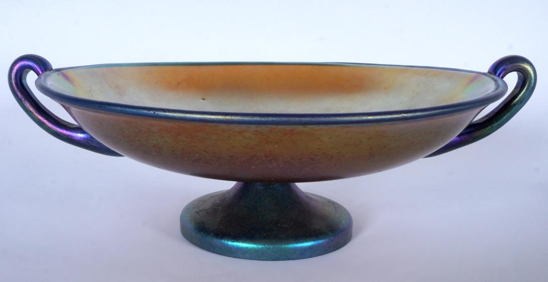 Loetz? Iridescent Footed Center Bowl / Compote: Bohemian iridescent gold glass double handled center bowl / compote, no visible markings, overall 4" h. x 11.5". Condition: Scratches.