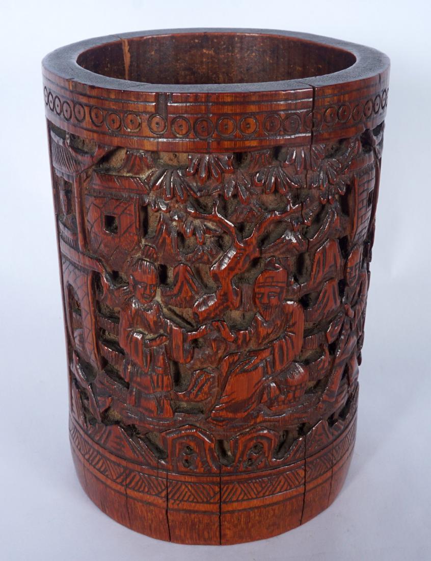 Chinese Carved Bamboo Scholars Brushpot: Qing dynasty scholars brushpot with carved outdoor genre scenes in panels, incised writing either side, measures 5" h. x 3.5". Condition: Several age splits.
