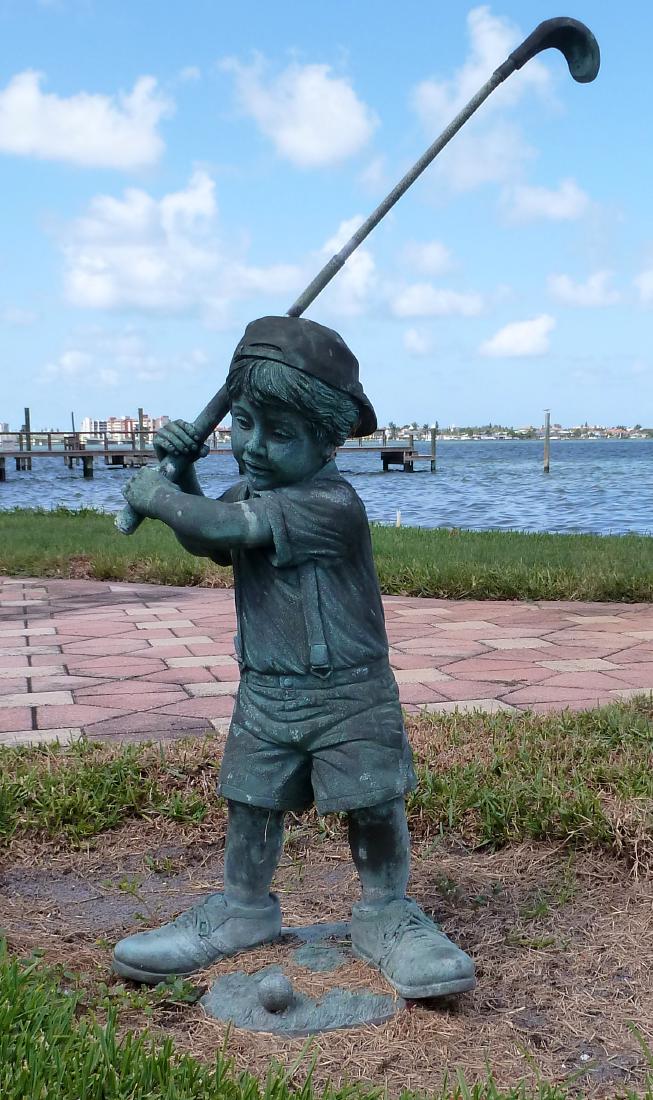 Garden Sculpture Bronze Boy Golfer: Figure of boy with golf club ready to swing, no visible signature, 47.25" h. x 24" x 13". Condition: Obvious weathering.