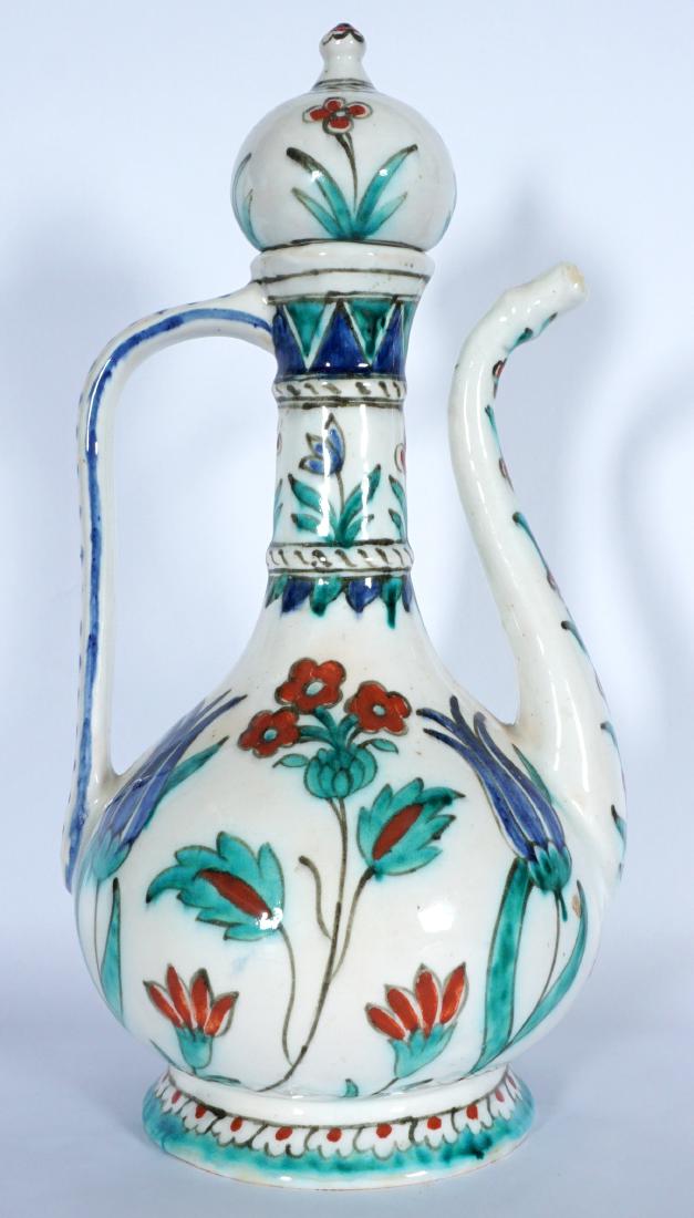Persian Pottery Teapot: Hand painted floral decorated motif, no visible markings, overall 11 1/4" h. x 6". Condition: Lid sits loose.
