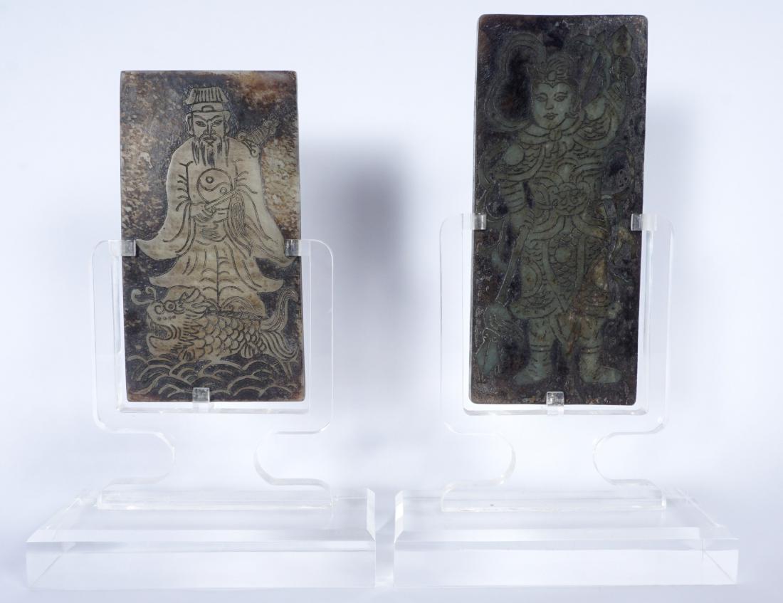 2 Chinese Carved Stone Plaques: 2 diminutive plaques to include 1) Warrior figure with polearm and mirror, archaic characters on back, 5.75" x 2.5" . 2) Deity figure with yin yang robe, standing on fish, archaic characters on back,