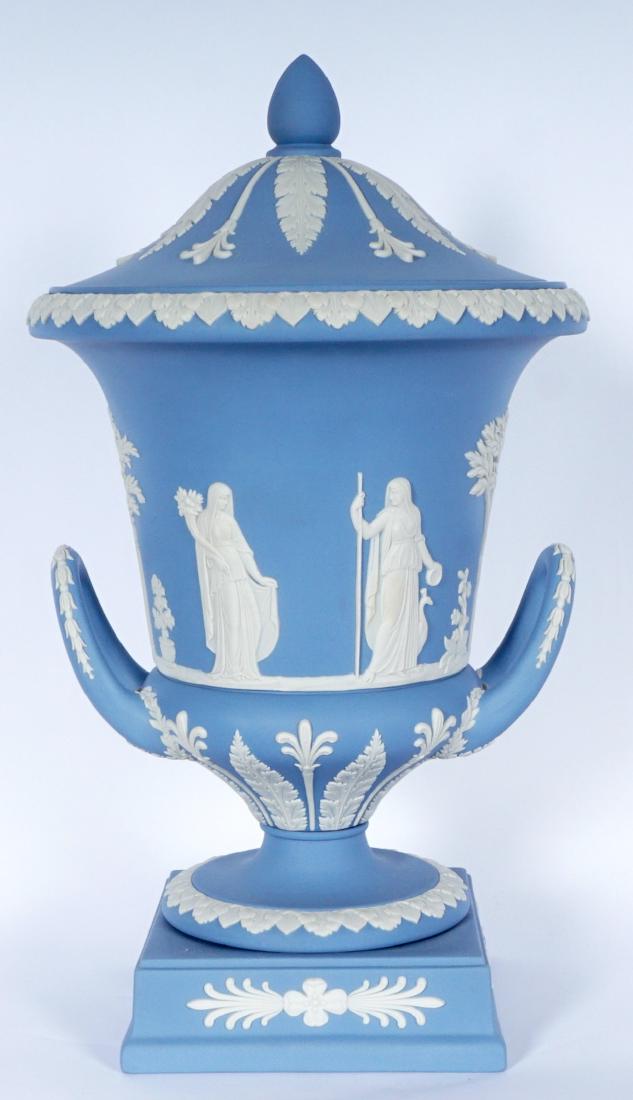 Wedgwood Jasperware Covered Urn: Pale blue ground, neoclassical and foliate motifs, double handle, impressed Wedgwood marks. 12" h. x 6 3/4".