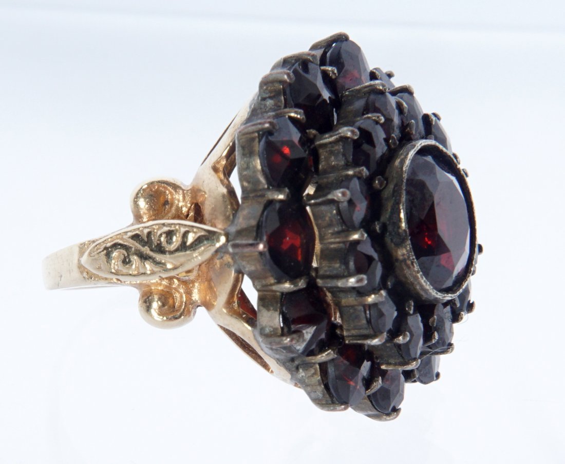14K & STERLING GARNET FLORAL RING: Floral cluster ring with garnets set in sterling silver on a 14K yellow gold band. Total weight 8 grams. Size 5. Diameter 22 mm.