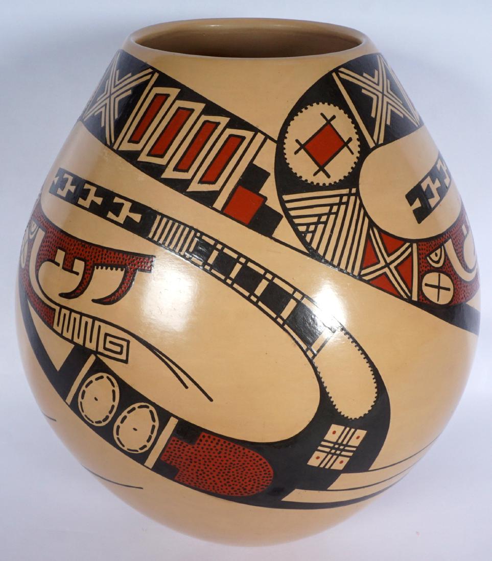 Juan Quezada Serpent Mata Ortiz Pottery Jar: Tan / brown ground , 3 polychrome stylized serpents, incised signature on base. Overall 10.25" x 8.5".