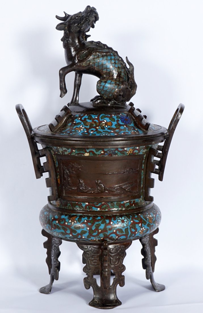 Large Chinese Bronze Champleve Censer: Figural Qilin finial with champleve scales, lid with floral motifs, double handled body, outdoor genre scene in relief panels, floral motif, on 4 legs. Overall 18.5" x 11.5".