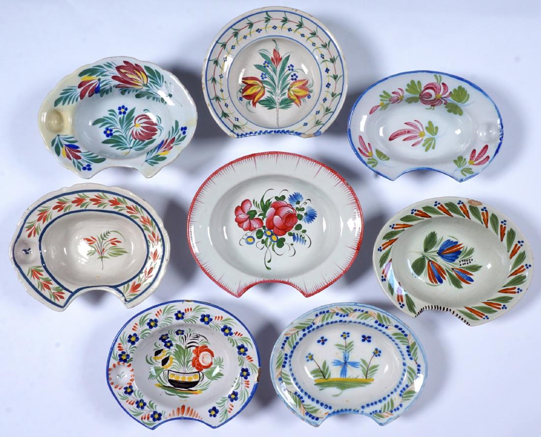 8 French Faience Shaving Bowls: An assembled collection of 8 total, floral motifs, largest measures 2.5" x 11.75" x 10". Condition: All with at least one chip, several with cracks and/or repairs.