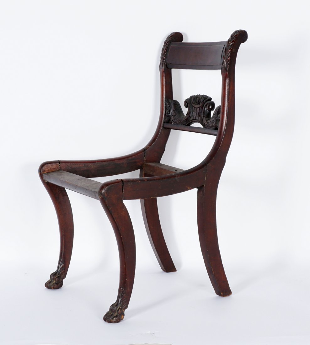 19th Century Duncan Phyfe Style Carved Side Chair: Mahogany chair frame only, most likely New York, carved acanthus leaf finials, center splat with carved basket and foliate motif. Saber legs, front legs ending in paw feet. Overall 32.75" h .x 18" x 2