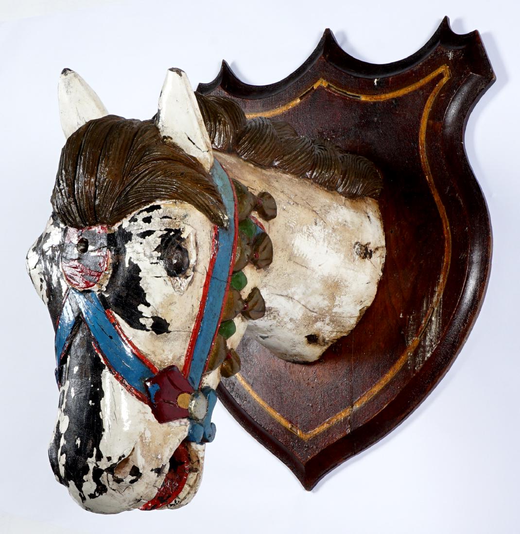 Polychrome Carved Figural Horse Head Plaque: Late 19th Century carved life size polychrome paint decorated figure of a horse head affixed to wall plaque mount. Overall 27" h. x 20.5" x 20.5". Condition: Horse with loss of paint, chip to ear, age