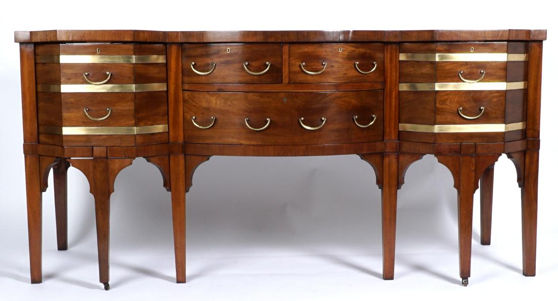 Georgian Mahogany Sideboard: Bowfront center with 2 felt lined fitted silverware drawers over single drawer. Felt lined angular front deep cellarette drawer either side, all on tapered legs. Overall 35.5" h. x 72.75" x 27.75". Co