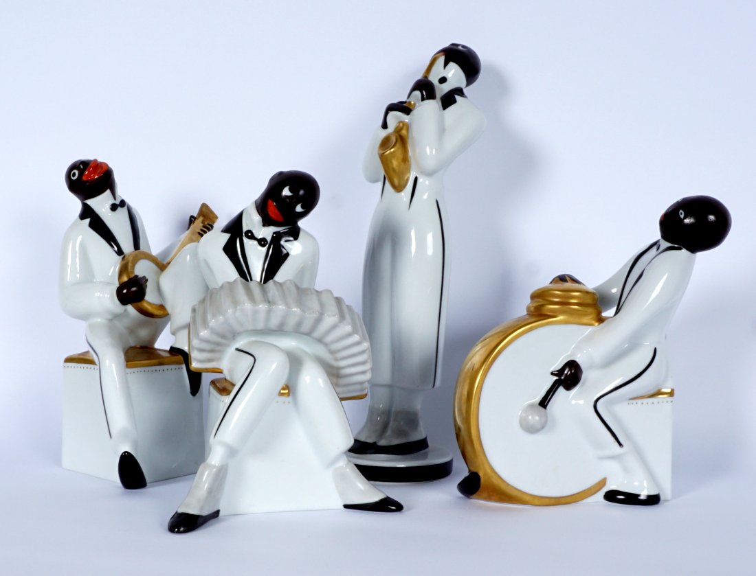Robj for Villeroy and Boch Porcelain Jazz Players: Four piece ensemble of hand painted jazz musicians designed by Robj for Villeroy & Boch, to include a saxophone player, banjo player, squeezebox player, and drummer. 2 are signed on bottom by Isabelle