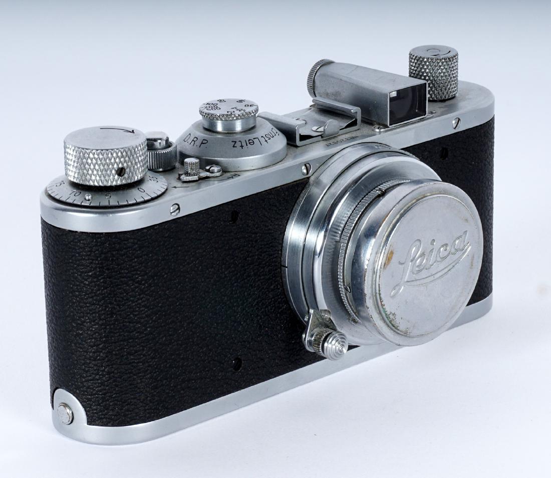 1939 Leica I Camera With Lens: Serial number 320927 dates to 1939, Leica I case, Ernst Leitz Wetzlar Summar f=5cm 1:2 No. 210962 lens. 2.75" x 5.25" x 2.5" Condition: Appears to be in working condition, however we are not camera ex