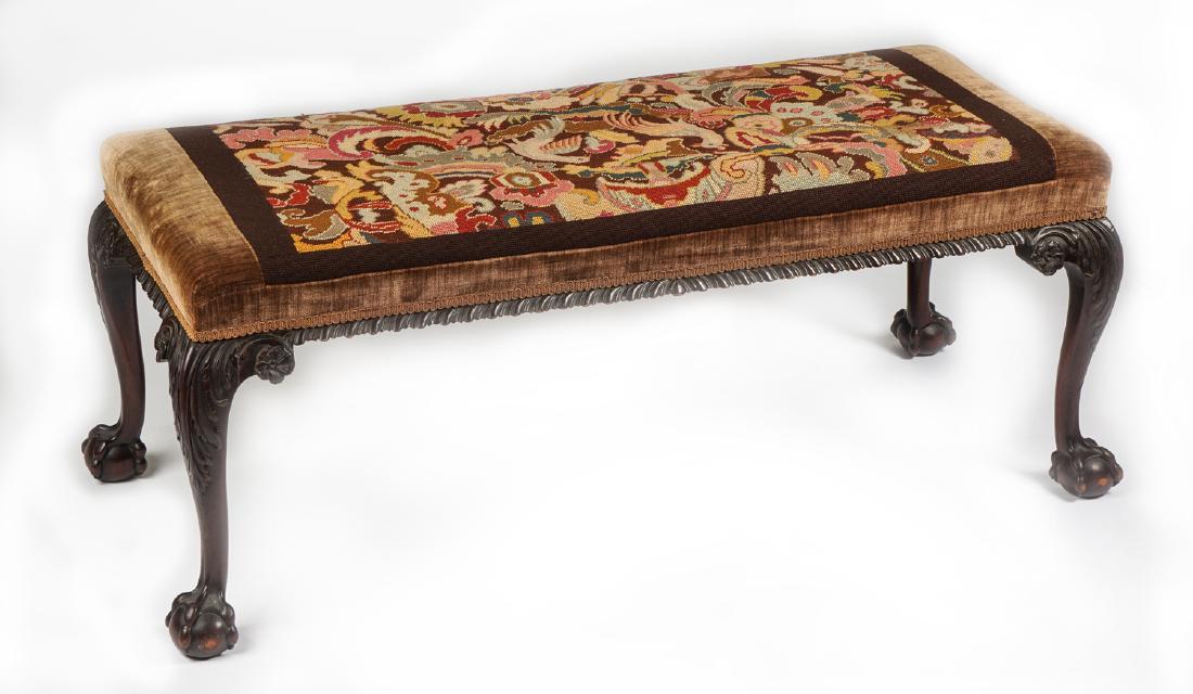 Georgian Style Needlepoint Covered Window Bench: Top with center needlepoint with 2 birds and floral decoration, brown upholstery, carved skirt, cabriole legs ending in claw and ball feet, 19.25" h. x 49" x 22". Condition: Wear consistent with age a