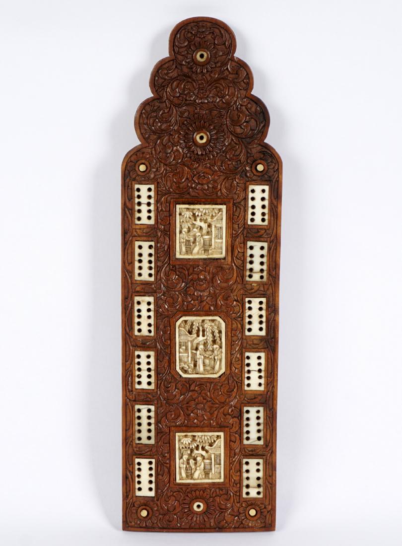 19th Century Chinese Carved Cribbage Board: Elaborate foliate scroll carved wood board with carved bone inserts, overall 9.5" long x 3".