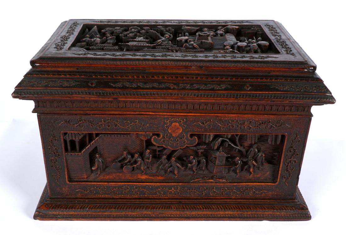 Chinese Carved Wood Dresser Box: Carved all over with various genre scenes in relief panels, foliate scroll accents, 8" h .x 14" x 9". Condition: On figure missing head on back, age split to lid.