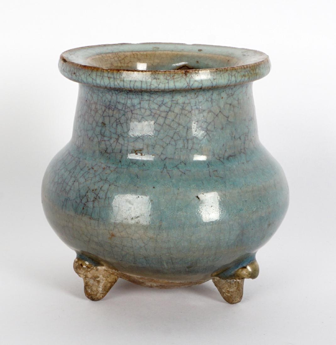 Chinese Junyao Yuan Ware Crackle Glaze Censer: Tripod footed censer, turquoise glaze with purple hues, squat from with flared rim, unglazed base, most likely Yuan Dynasty (1279-1638). Measures 4" h .x 4.25". Condition: Chips to lip, crazing, no cr