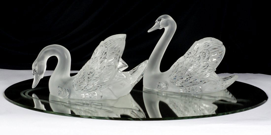 Pair Large Lalique Frosted Swans on Mirror: "Miroir Cygnes", pair of large swans on etched mirrored plateau, each signed Lalique France, taller swan measures 8.75" h. x 13" x 7.5", mirror 33" x 22.5". Condition: Fleabite to one swan, chip to ed