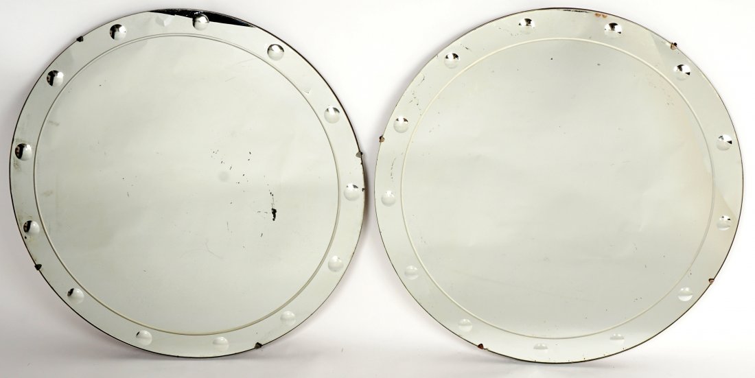 Pair Manner of Fornasetti Round Wall Mirrors: Round mirrors with small dimpled accents border, 24" dia., no labels. Condition: Spotting to mirrors.