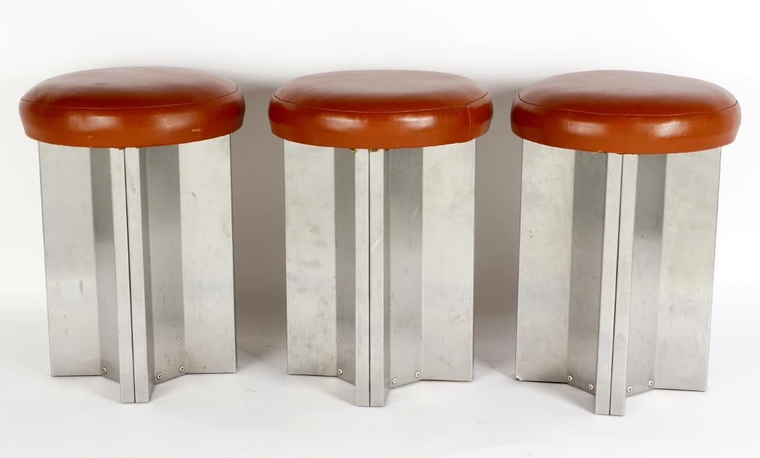 3 Maison Jansen Brushed Steel Stools: Brown round leather seat over brushed steel base, unmarked, overall 17.5" h. x 13" dia. Condition: Scratches to bases, other wear consistent with age and use.