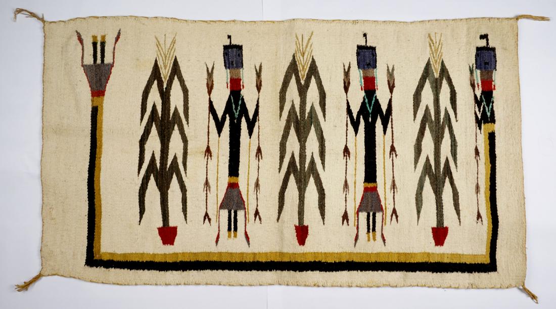 1940's Navajo Four Figure Yei Rug 31" x 56": 1940's cotton, four figures with corn stalks, reputedly originally purchased at Fred Harvey Trading Company. Overall 31" x 56". Condition: Overall good with minor fade and wear.